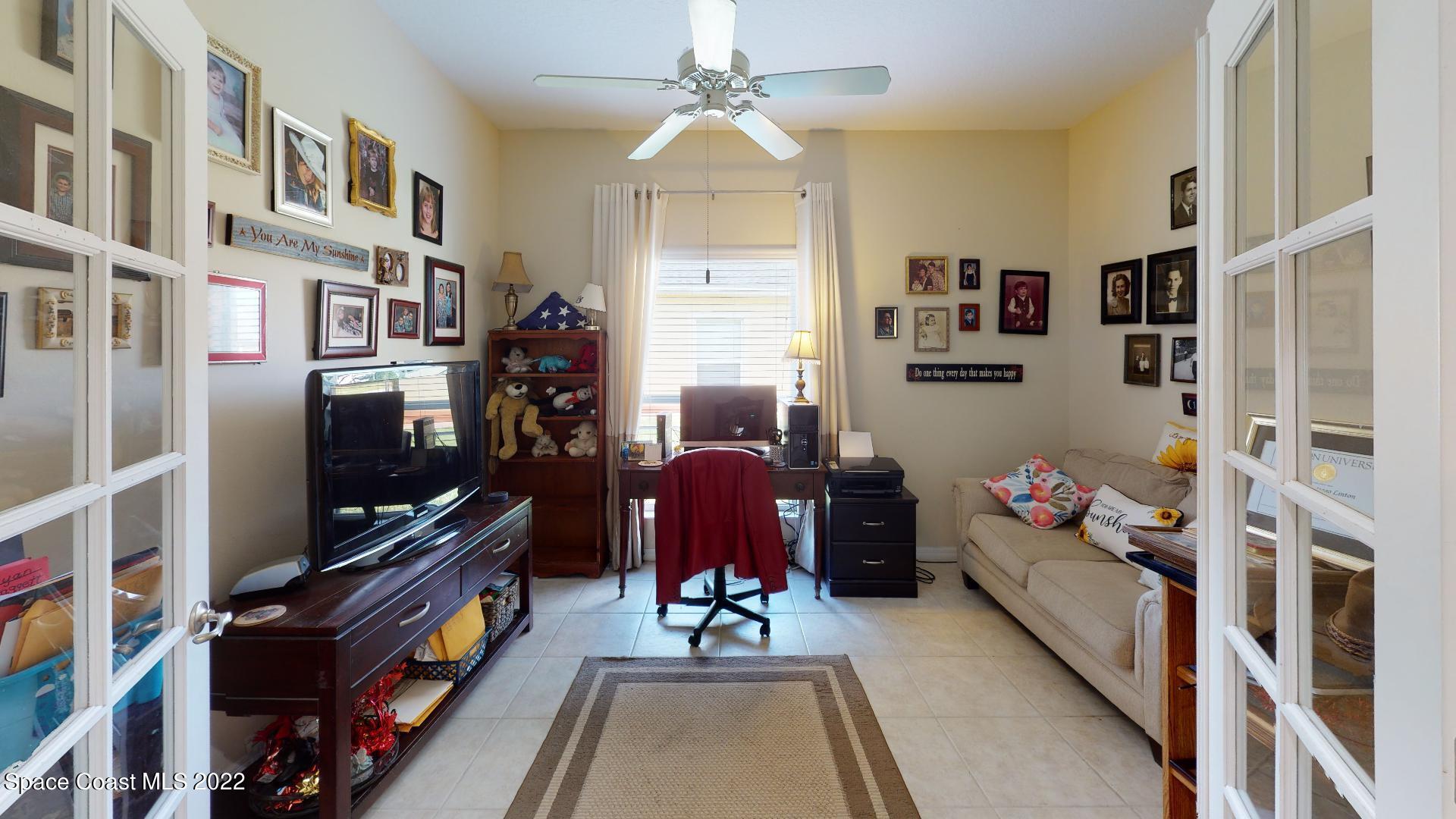 3151 Le Conte Street Melbourne, FL 32940 - Photo 24 of 30 a living room with furniture and a flat screen tv