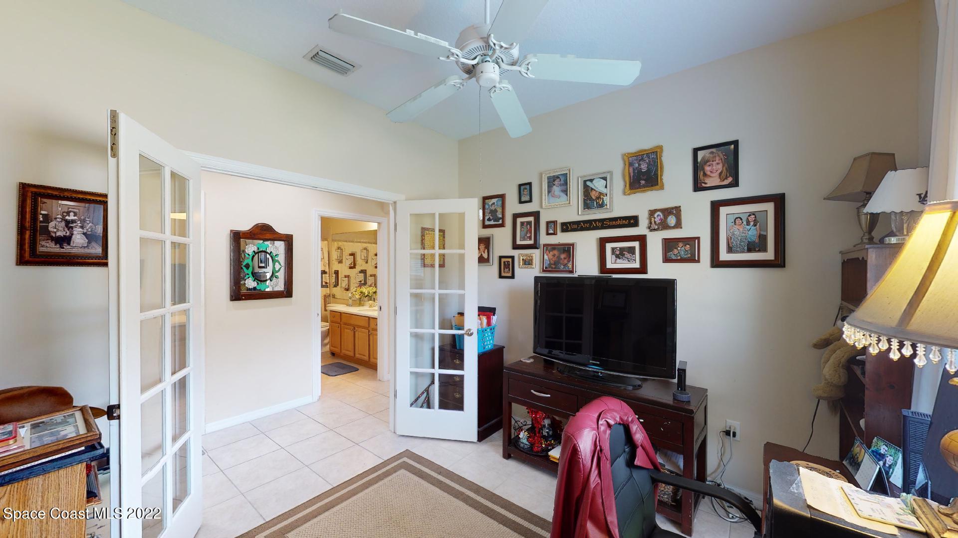 3151 Le Conte Street Melbourne, FL 32940 - Photo 25 of 30 a living room with furniture and a flat screen tv