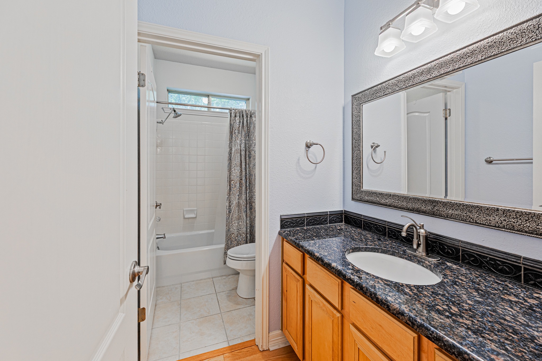 304 River Down Road Georgetown, TX 78628 - Photo 14 of 22 Bathroom vanity featuring a granite countertop, undermount sink, and wood cabinetry