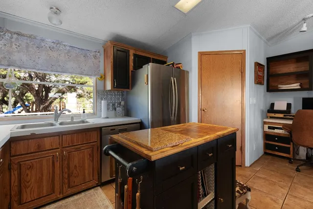 a kitchen with a stove a sink and a refrigerator