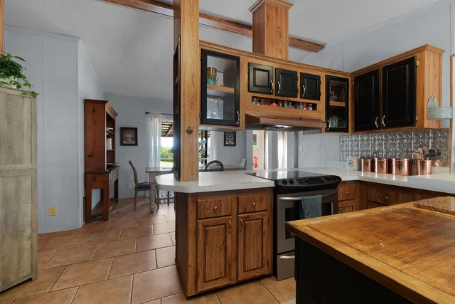 a kitchen with stainless steel appliances granite countertop a stove and a refrigerator