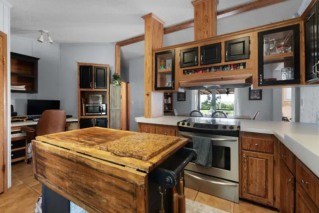 a kitchen with stainless steel appliances kitchen island a large stove a sink dishwasher and microwave oven with cabinets