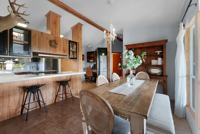 a view of a dining room with furniture and chandelier