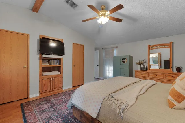 a bedroom with a bed and a television