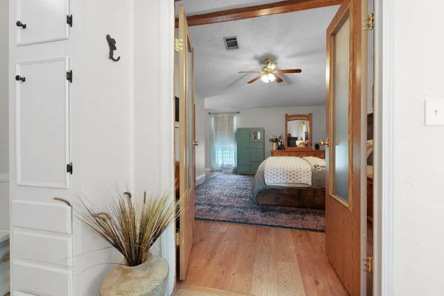 a living room with furniture flowerpot and a chandelier