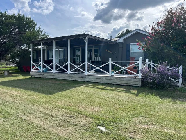 a view of a house with swimming pool and sitting area