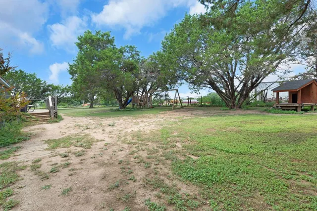 a view of a tree in front of a house