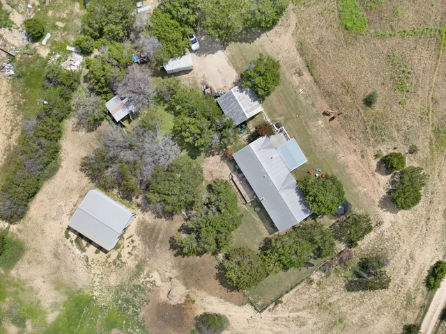 an aerial view of a house with a yard