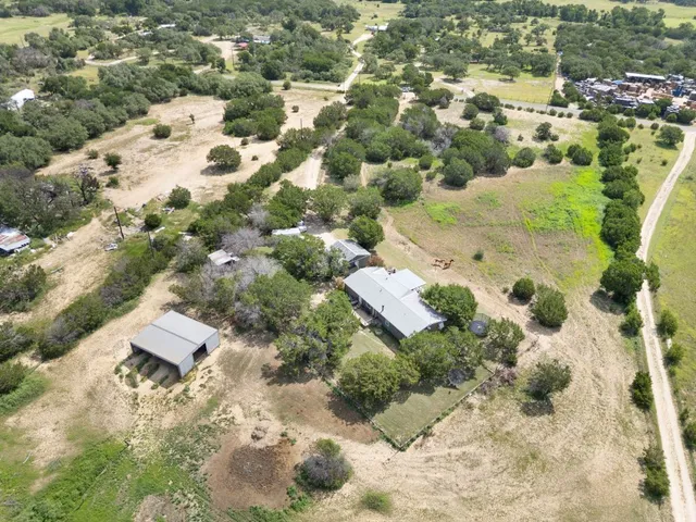 an aerial view of a house with a yard