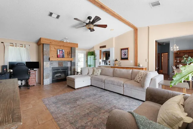 a living room with furniture and a fireplace