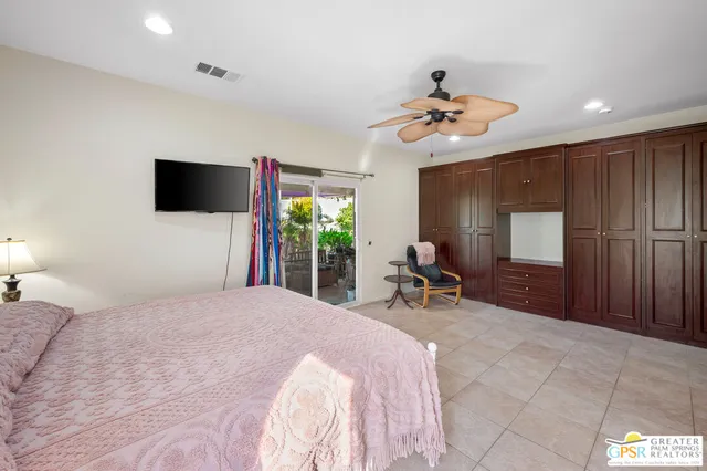 a bedroom with a bed and a chair