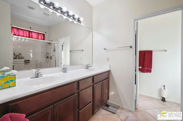 a bathroom with a sink vanity granite shower and a mirror