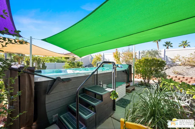 a view of a chairs and table in backyard