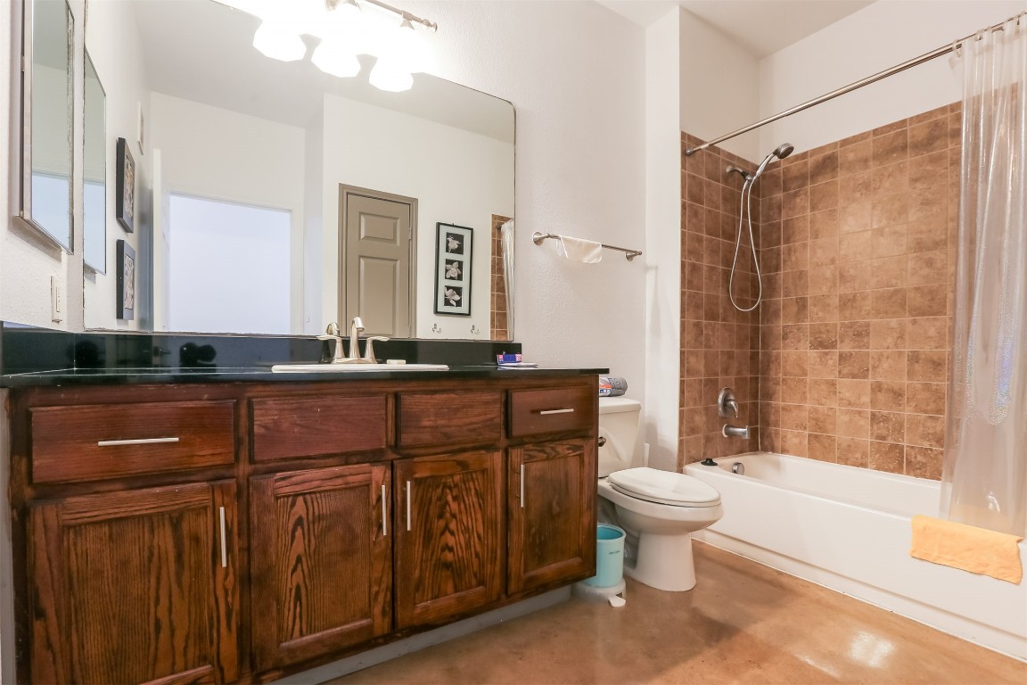 910 West 25th Street, Unit 509 Austin, TX 78705 - Photo 14 of 31 a bathroom with a sink a toilet and shower