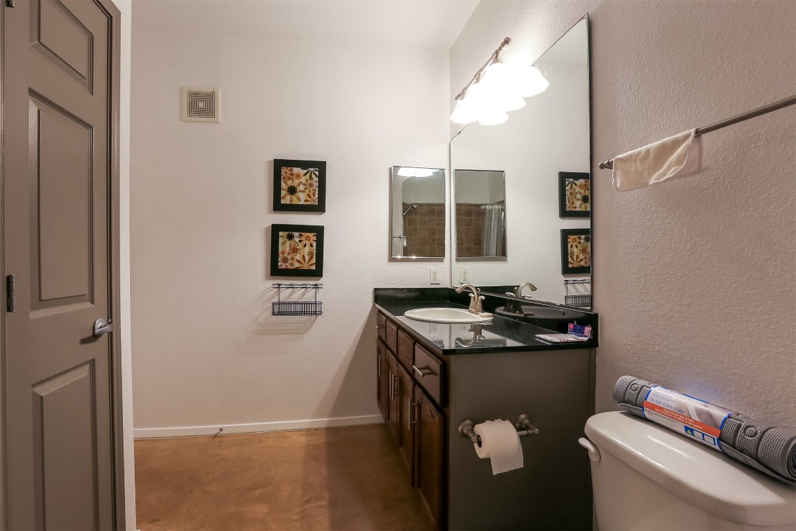 910 West 25th Street, Unit 509 Austin, TX 78705 - Photo 16 of 31 a bathroom with a granite countertop sink a toilet and a shower
