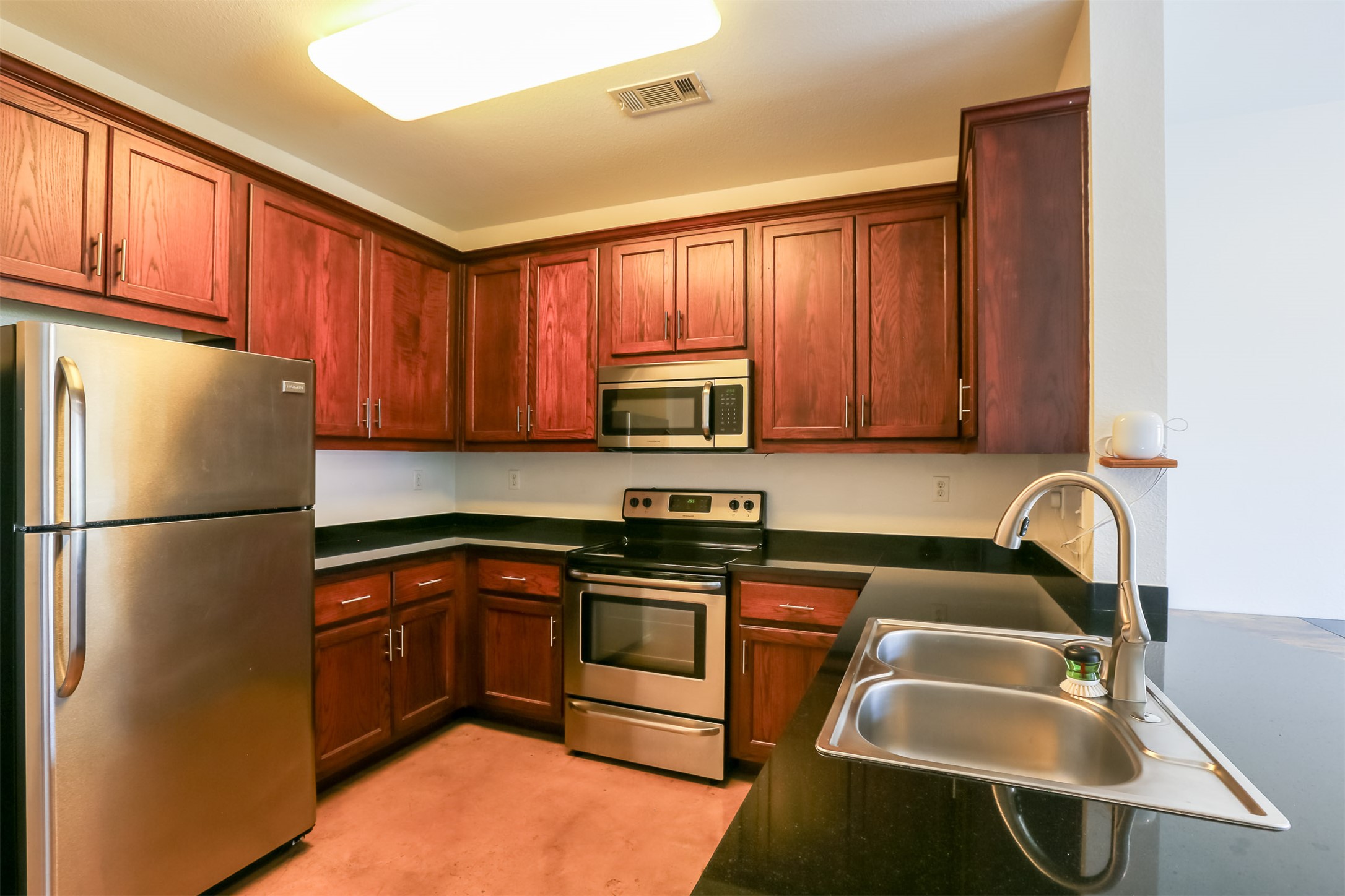 910 West 25th Street, Unit 509 Austin, TX 78705 - Photo 9 of 31 a kitchen with a refrigerator sink and cabinets