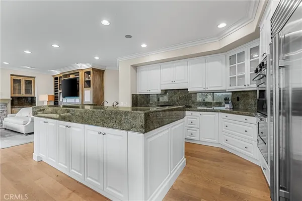 a kitchen with stainless steel appliances granite countertop a stove and a sink