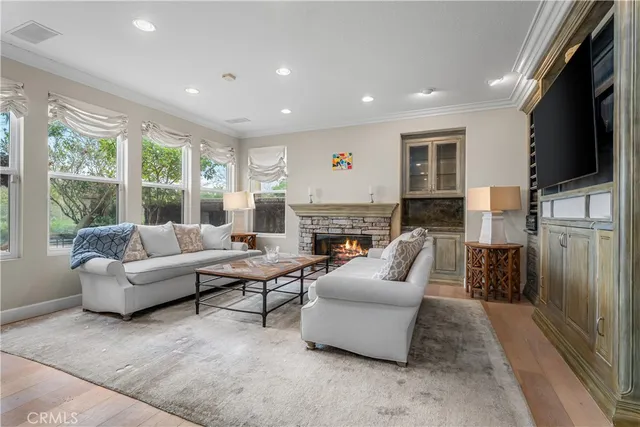 a living room with fireplace furniture and a flat screen tv