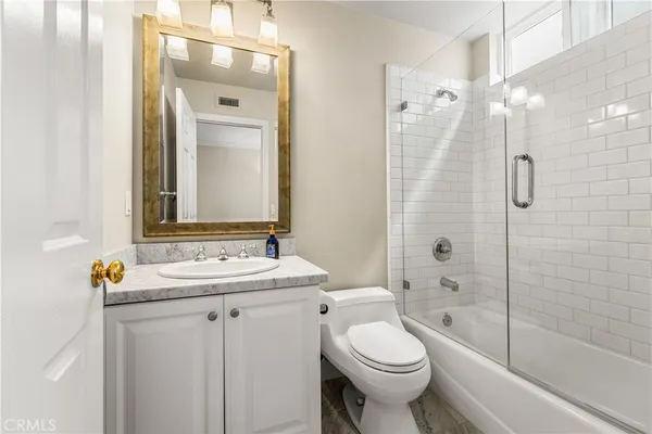 a spacious bathroom with a granite countertop tub sink and mirror