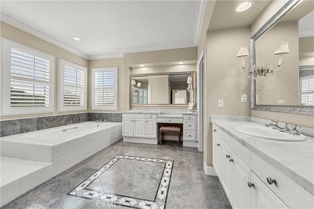 a en suite bathroom with a double vanity sink and a mirror