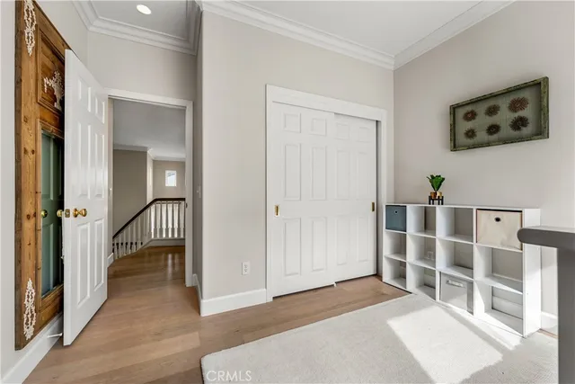 a view of small white house with a small yard and plants