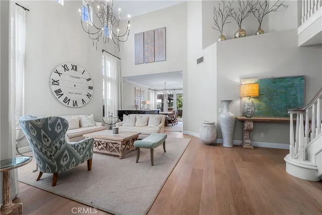 a living room with fireplace furniture and a chandelier
