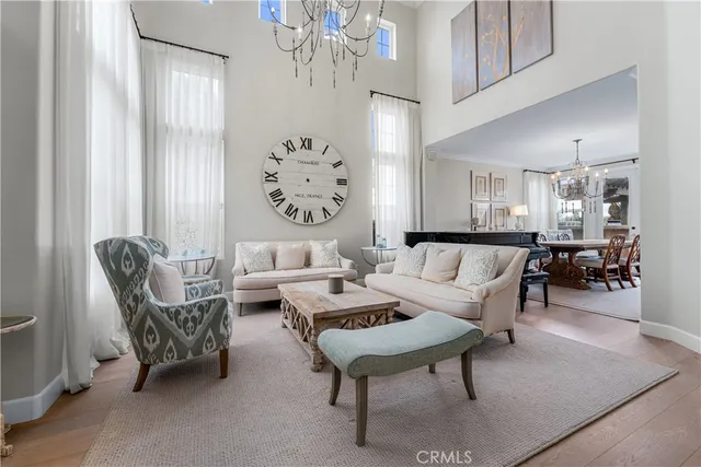 a living room with furniture a chandelier and a painting on the wall