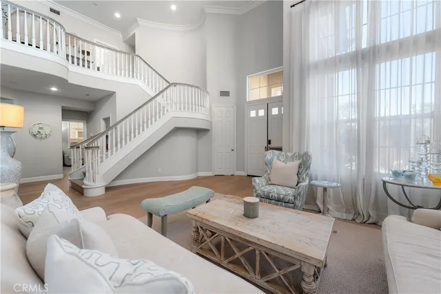 a living room with furniture and stairs