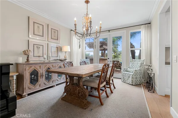 a view of a dining room with furniture and a chandelier