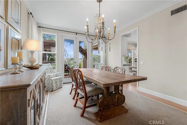 a view of a dining room with furniture and a chandelier