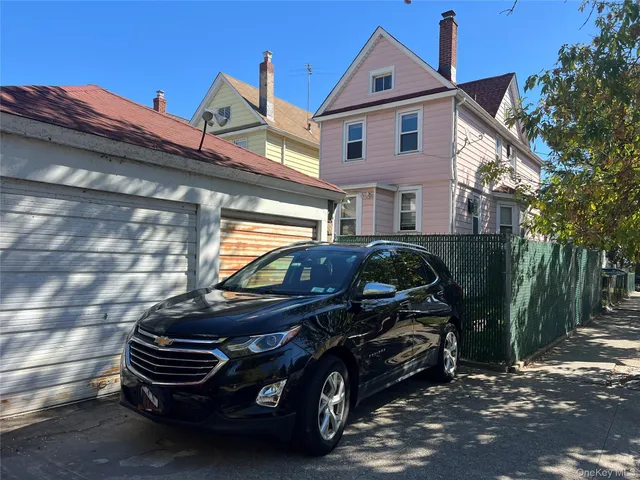a front view of a house with parking space