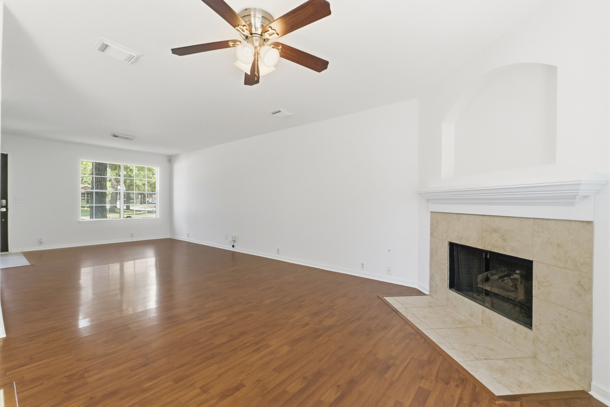 11907 Ezekiel Road Tomball, TX 77375 - Photo 9 of 39 a view of empty room with wooden floor and fireplace