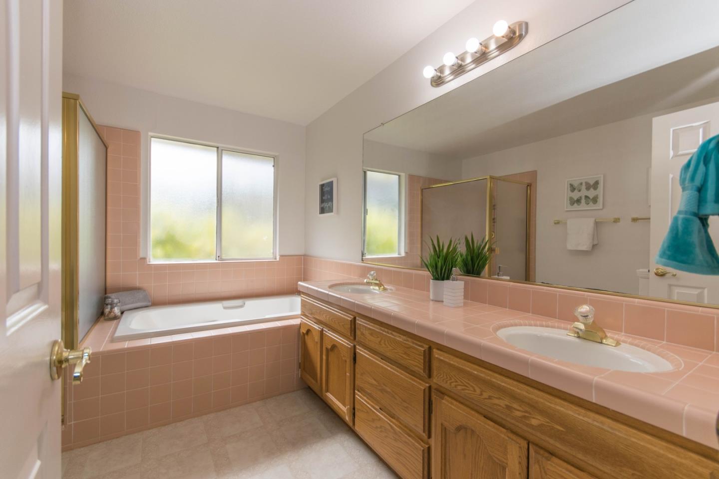 5980 Stone Bridge Road Santa Rosa, CA 95409 - Photo 13 of 24 a bathroom with a granite countertop sink mirror and a bathtub