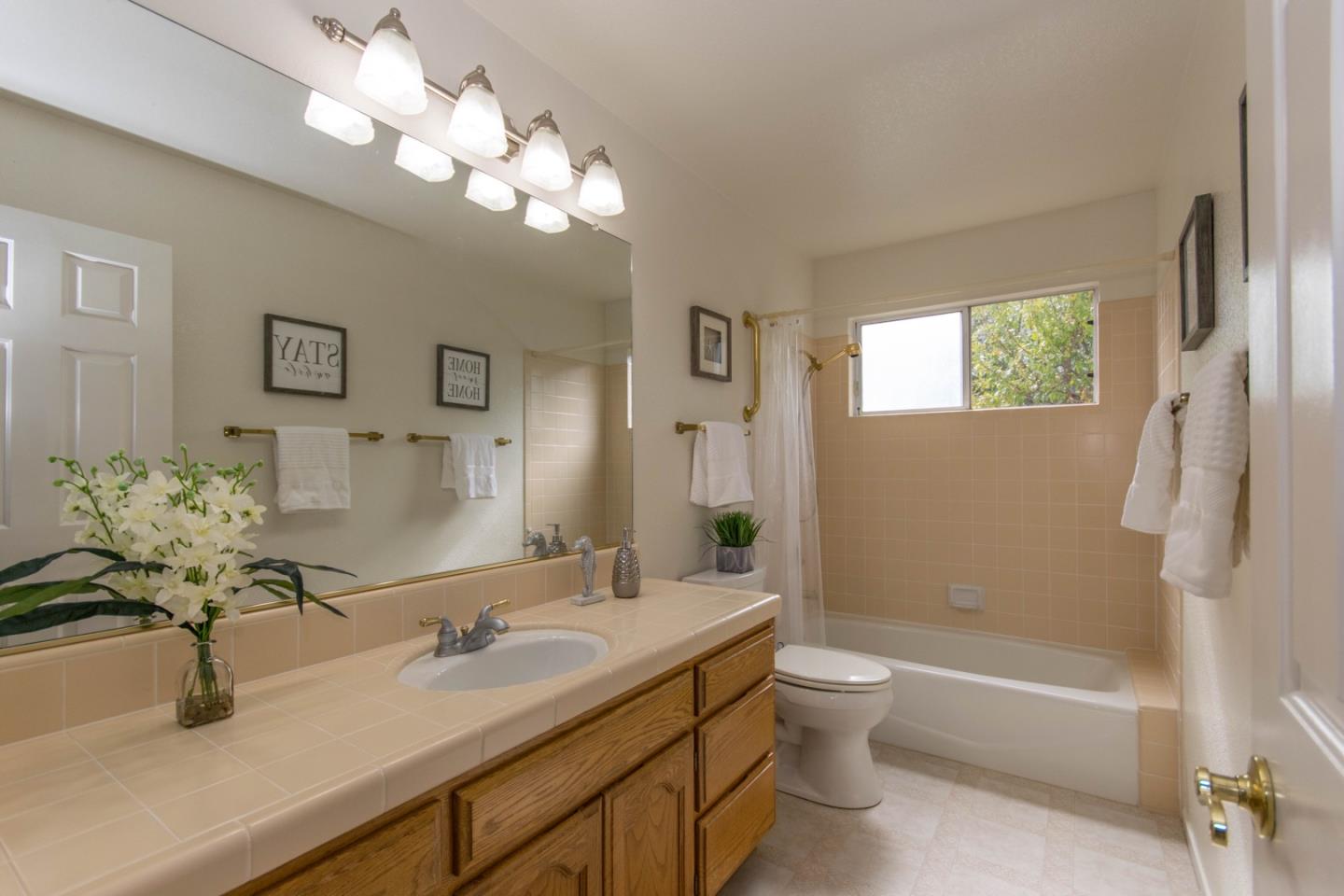 5980 Stone Bridge Road Santa Rosa, CA 95409 - Photo 18 of 24 a bathroom with a tub a sink and mirror