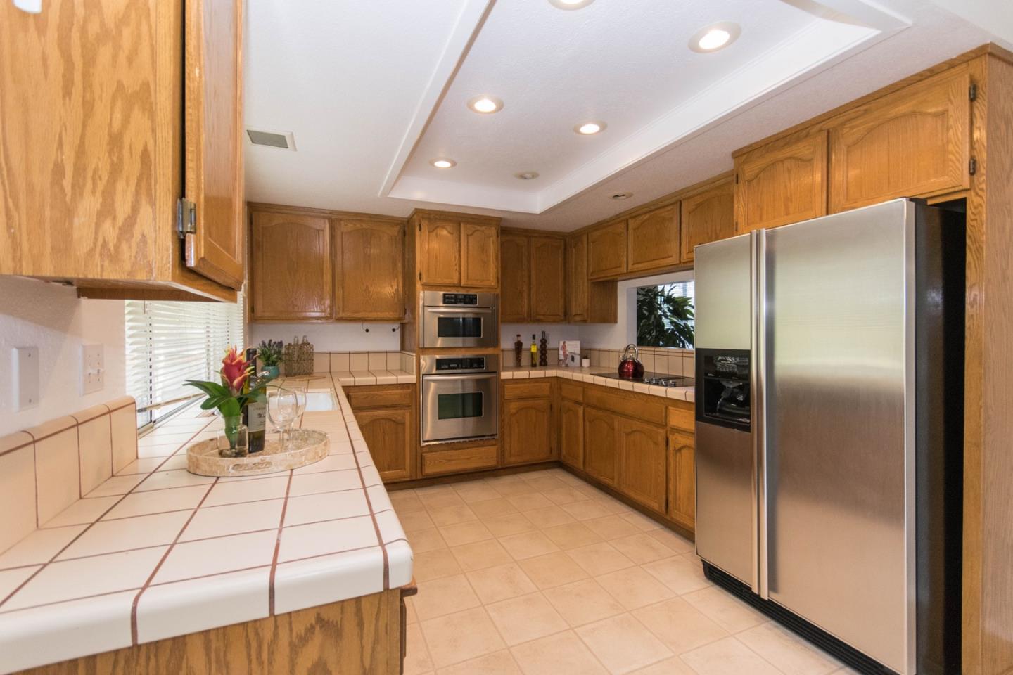 5980 Stone Bridge Road Santa Rosa, CA 95409 - Photo 7 of 24 a kitchen with stainless steel appliances a refrigerator sink and cabinets