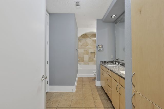 an empty room with closet and windows