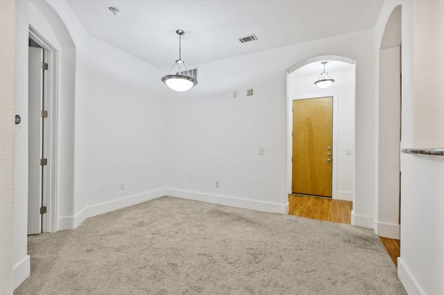a view of a kitchen with a sink and a cabinet mirror