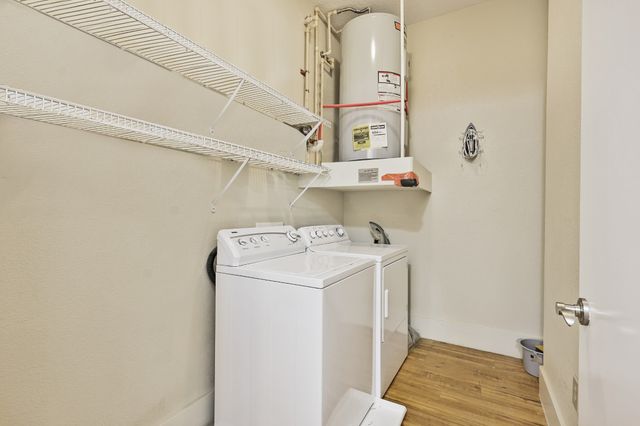 a kitchen with cabinets appliances and a window