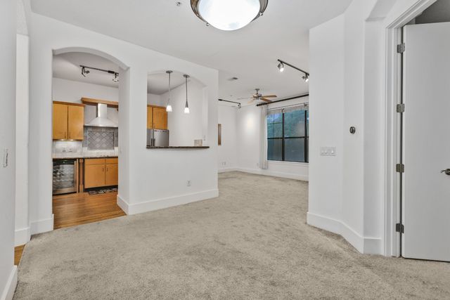 a kitchen with stainless steel appliances granite countertop a sink and a refrigerator