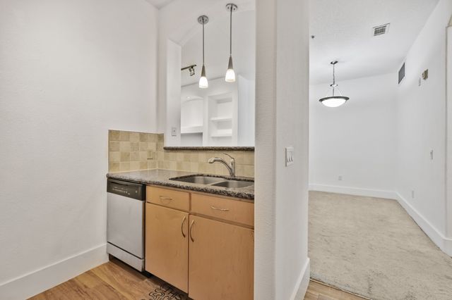 a view of a livingroom with a ceiling fan and window