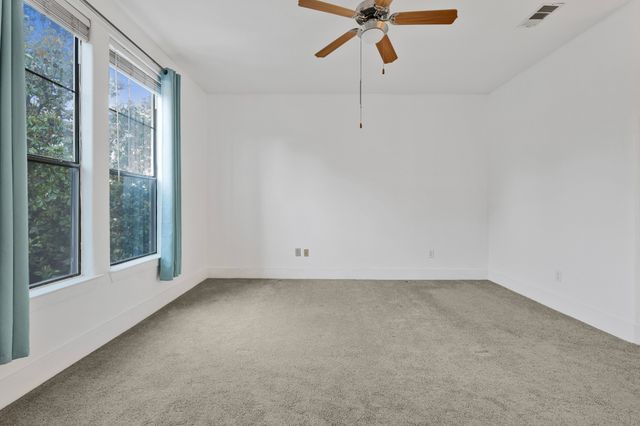 a bathroom with a granite countertop sink a mirror a bathtub and shower