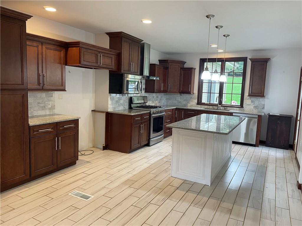 656 Cheese Run Road Indiana, PA 15701 - Photo 2 of 16 a large kitchen with stainless steel appliances granite countertop a stove a sink dishwasher and a refrigerator