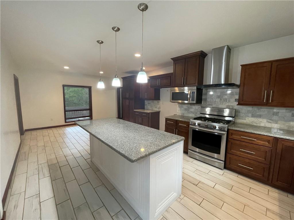 656 Cheese Run Road Indiana, PA 15701 - Photo 3 of 16 a kitchen with stainless steel appliances granite countertop a stove a sink and a refrigerator