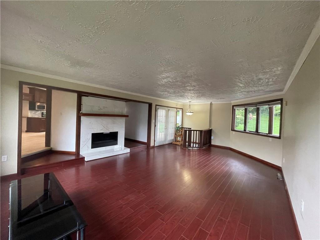 656 Cheese Run Road Indiana, PA 15701 - Photo 5 of 16 a view of empty room with wooden floor and fireplace