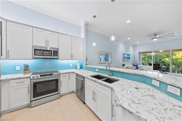 a kitchen that has a sink and a stove