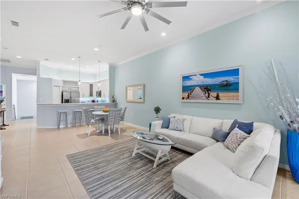 a living room with furniture a flat screen tv and a large window