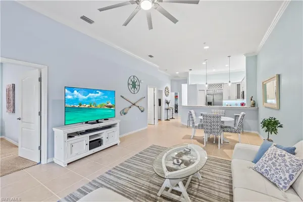 a living room with furniture and view of kitchen