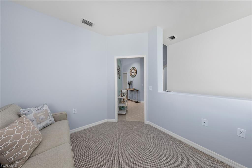 1285 Sweetwater Cove, Unit 2106 Naples, FL 34110 - Photo 21 of 38 a bedroom with a bed and closet