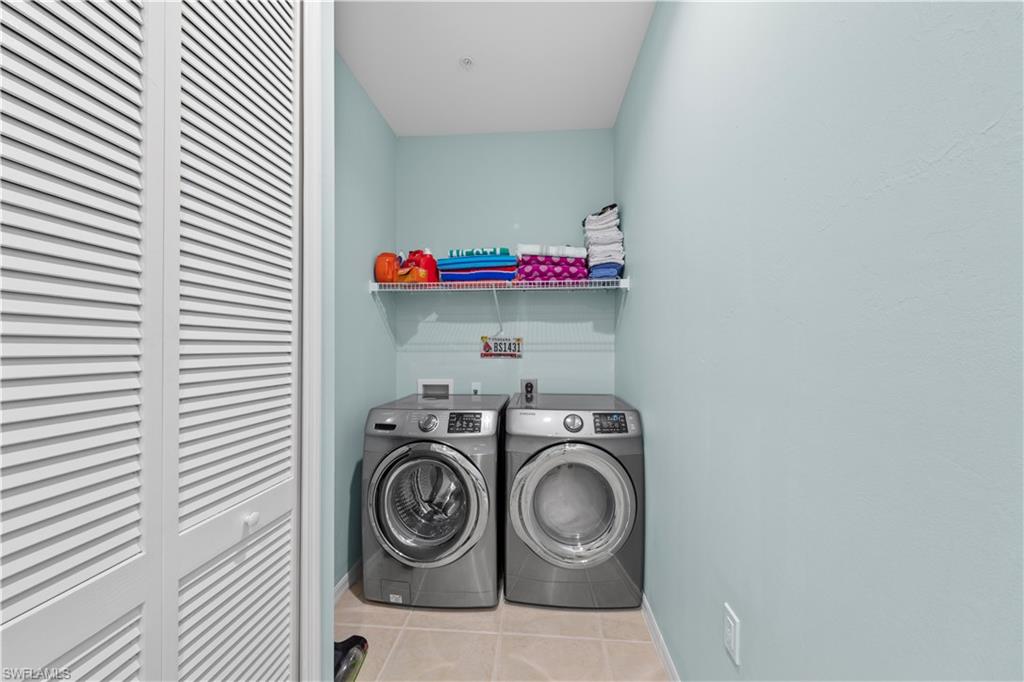1285 Sweetwater Cove, Unit 2106 Naples, FL 34110 - Photo 22 of 38 a utility room with dryer and washer