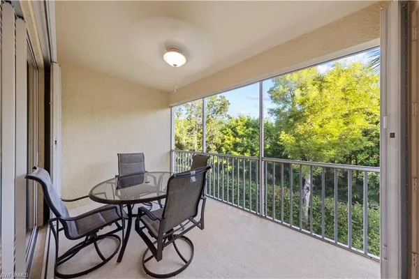 a dining room with furniture and a floor to ceiling window